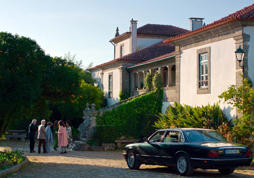 event image:A group of people and a car in front of a house